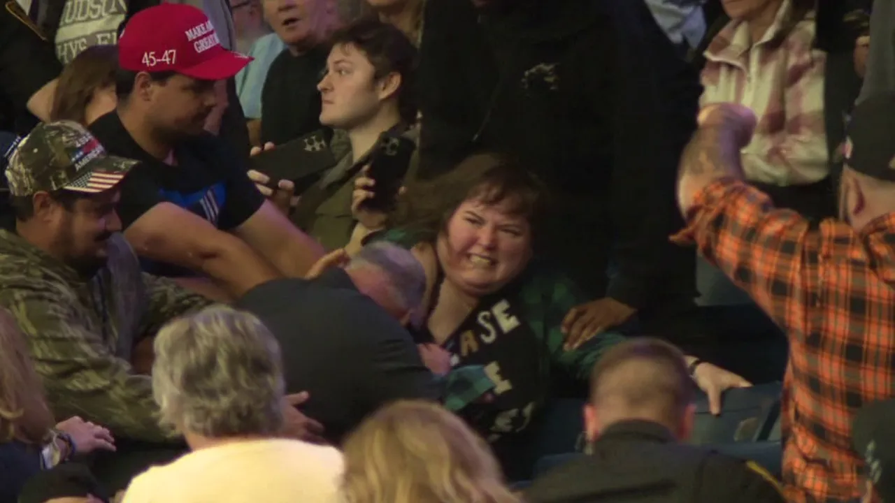 Woman protestor being attacked at Trump rally in Youngstown, Ohio, on October 12, 2026.